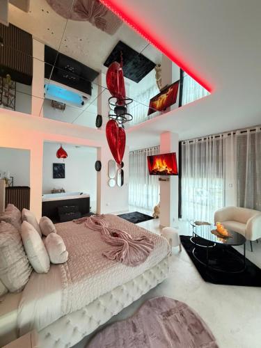 a bedroom with a large bed and a red beam at Studio de Charme VERSAILLES in Versailles