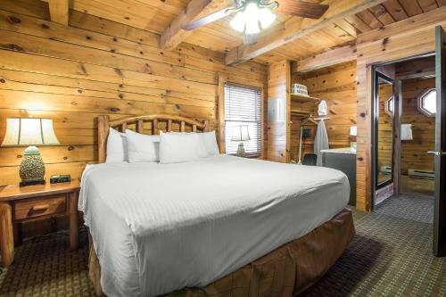 a bedroom with a bed in a log cabin at Bluegreen Vacations Christmas Mountain Village, an Ascend Collection Resort in Wisconsin Dells