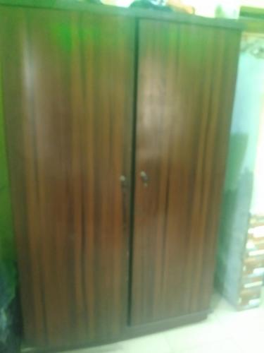 a pair of wooden cabinets in a room at Ensuite in Ejigbo