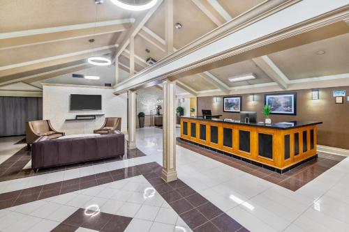 a lobby of a hospital with a couch and a tv at Rodeway Inn Festival in Stratford