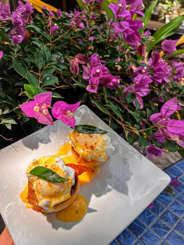 a plate of food on a table with flowers at Sundaras Infinity Jungle Resort & Spa in Dambulla