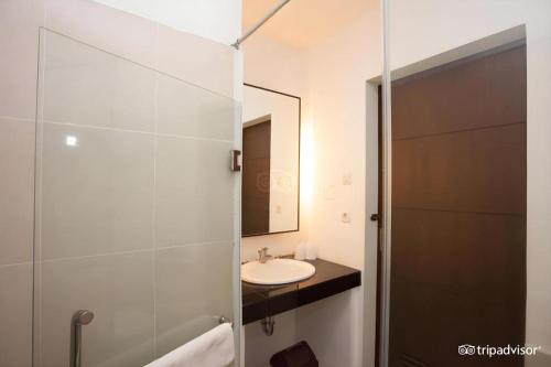 a bathroom with a sink and a toilet and a mirror at Casa Monte Rosa in Puncak