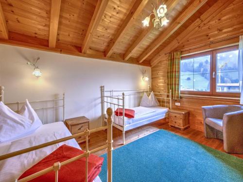 a bedroom with two bunk beds and a couch at Holiday Village Wildschönau Traditional Chalet in Niederau