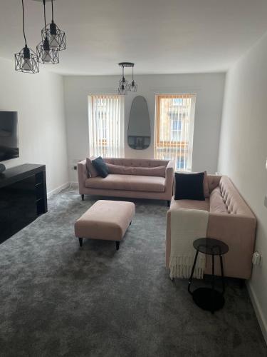 a living room with two couches and a tv at Maison 109 Suite - Modern City Apartment in Glasgow