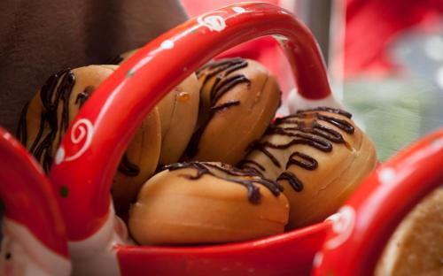 a red container filled with chocolate covered donuts at Heritage Park Hotel in Honiara