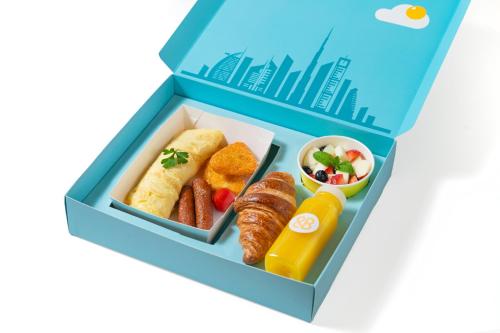a blue lunch box with food in it at Luxury apartments at Vida Residences in Dubai