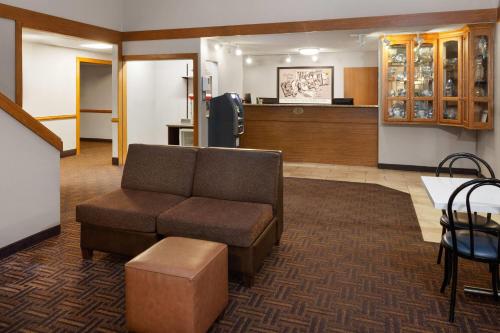 a waiting room with a couch and a table at Super 8 by Wyndham Green Bay Near Stadium in Green Bay