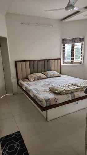 a bedroom with a large bed in a room at Samta in Vadodara