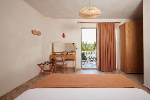 a bedroom with a bed and a desk with a chair at Villa Castelle in Marmaris