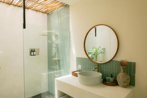a bathroom with a sink and a mirror at Summer Promo - 2 BR villa, big pool & garden in Kuta Lombok