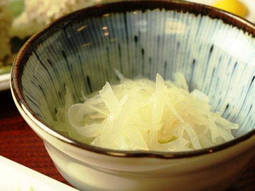 a bowl full of onions sitting on a table at Chouchinya in Nozawa Onsen
