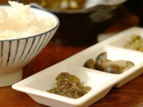 a bowl of rice and a plate of food with mushrooms at Chouchinya in Nozawa Onsen