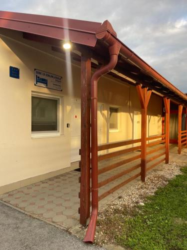 a metal roof on a house with a porch at Rooms Jelengrad in Petrijevci