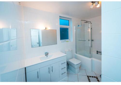 a bathroom with a toilet and a sink and a shower at Cozy room in yellow in Sale