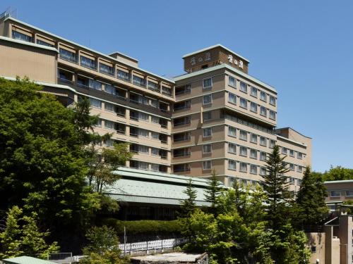 a large building with a clock tower on top of it at jyozankei SHIKAnoYU in Jozankei