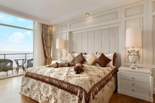 a bedroom with a bed with a dog on it at Ramada by Wyndham Baku in Baku