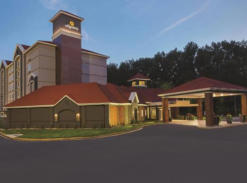 a rendering of a building with a tower on top at La Quinta by Wyndham Atlanta Alpharetta in Alpharetta