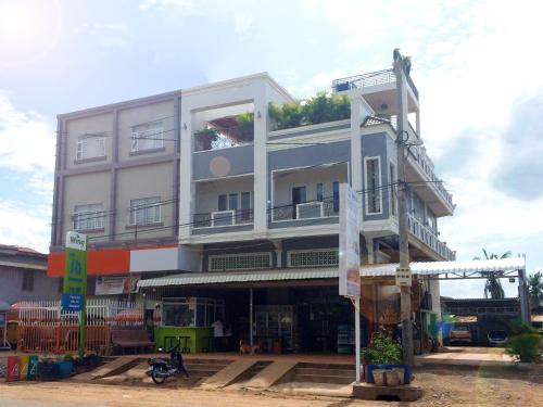 a large white building with a store front at Sokha Home in Bahal
