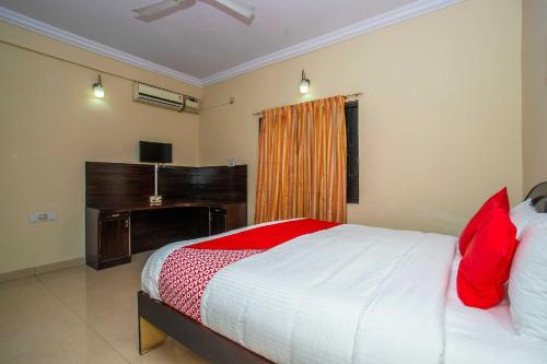 a bedroom with a large bed and a piano at RC Resort by Palette Homes I Kovalam Beach I ECR in Perunkalattu