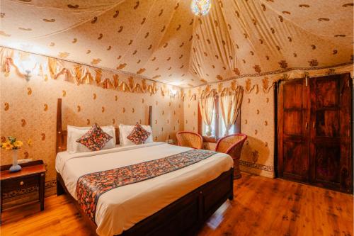 een slaapkamer met een bed in een tent bij The Saipura Bagh Resort-Jaipur in Jaipur