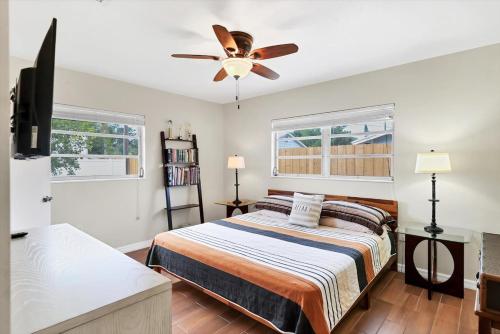 a bedroom with a bed and a ceiling fan at Charming 3BR Retreat Near Sarasota Beaches in Sarasota