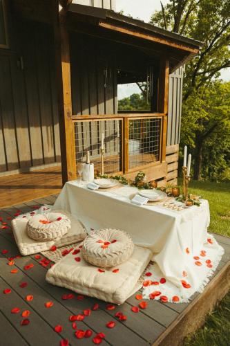 a table with two cakes on top of a table at Magical Tennessee Tiny House with a Rooftop Deck in Maryville