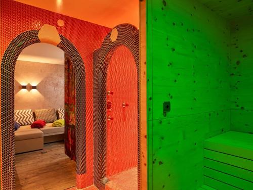 a room with a green wall and a green door at Boutique Appartments Gerlosperle in Gerlos