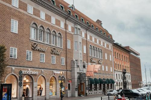 a large brick building on a city street at Home Hotel Grand Helsingborg in Helsingborg