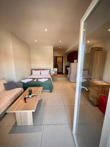 a bedroom with a bed and a table in a room at Fillio 's Apartment, Ptolemaida in Ptolemaida