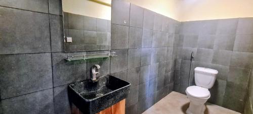 a bathroom with a toilet and a sink at Sun Hostel and Restaurant Kampot in Kampot