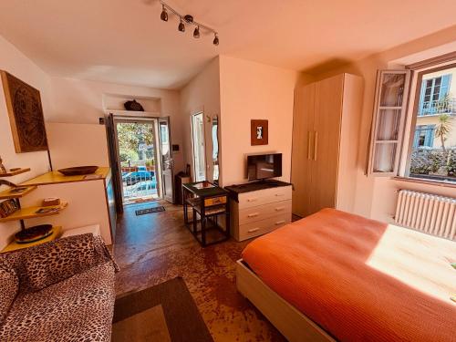 a bedroom with a bed and a desk and a television at Barbara House in Como