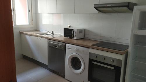 a kitchen with a washing machine and a sink at Calatorao apartamentos in Calatorao