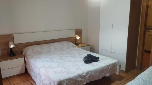 a bedroom with a bed with a pair of shoes on it at Calatorao apartamentos in Calatorao