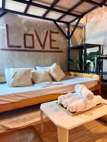 a room with two beds and a table with towels on it at LoftVibes San Juan - 4 in San Juan