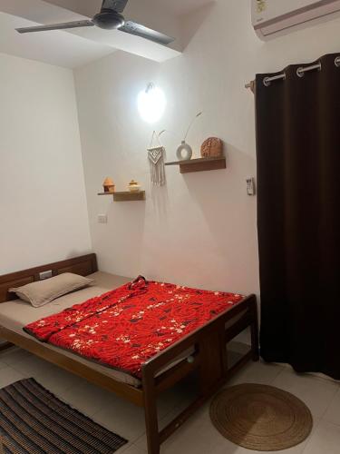 a bed in a room with a ceiling fan at Bayou Homestay and backwaters in Goa