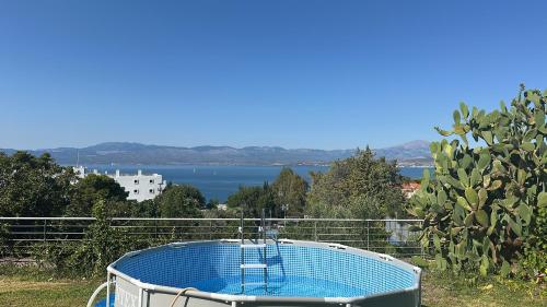 a hot tub with a view of the water at Caecilia & Lawrence Villa in Chalkida