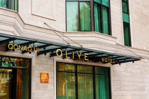 a hotel sign on the front of a building at Olive Boutique Hotel in Almaty