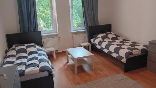 a living room with two beds and a table at Crew Quartier ALL-INCLUSIVE Serviced Apartment in Krostitz in Krostitz