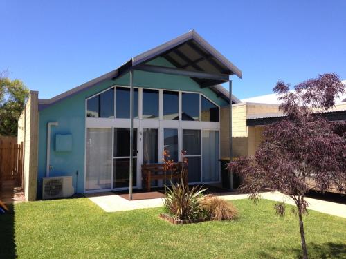 a house with large glass windows and a yard at One Dillon in Emu Point