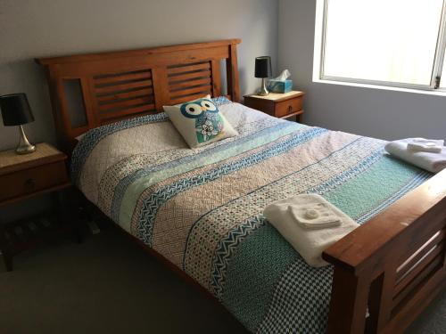 a bedroom with a bed with two pillows on it at One Dillon in Emu Point