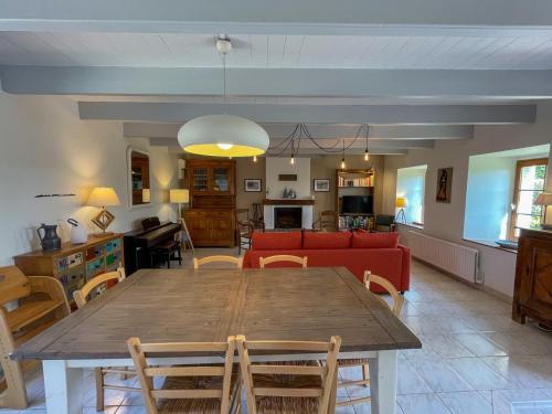 a dining room and living room with a table and chairs at Ty Levenez in Paimpol