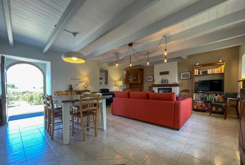 a living room with a red couch and a table at Ty Levenez in Paimpol