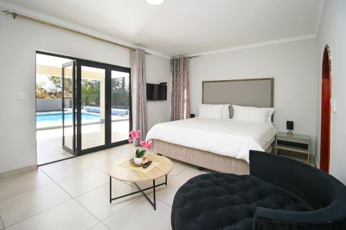 a bedroom with a bed and a couch and a pool at honeymoon suite in Sandton