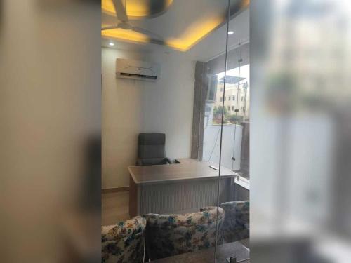 an office with a desk and a chair in a room at Hotel O Lavish Hotel in Greater Noida