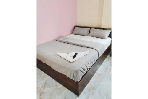 a bed with a napkin on top of it at HOTEL O THE HOTEL TRIYA in Warangal