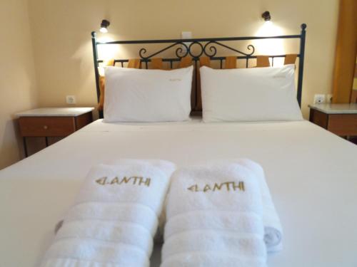 a bed with white towels on it at Elanthi Village Apartments in Kalamaki