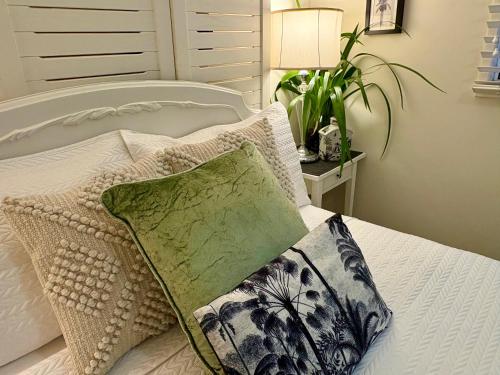 a bedroom with a bed with a pillow and a lamp at Jacaranda House Garden Suite in Brisbane