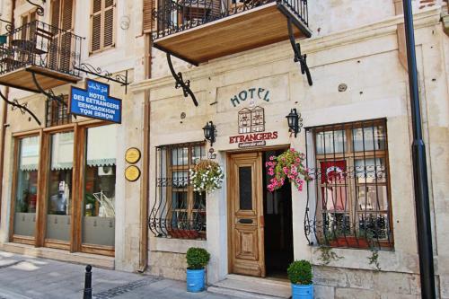 a building on a street with a store at Hotel Des Etrangers - Special Category in Çanakkale