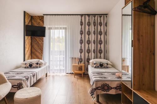 a room with two beds and a window at Willa Józef in Zakopane