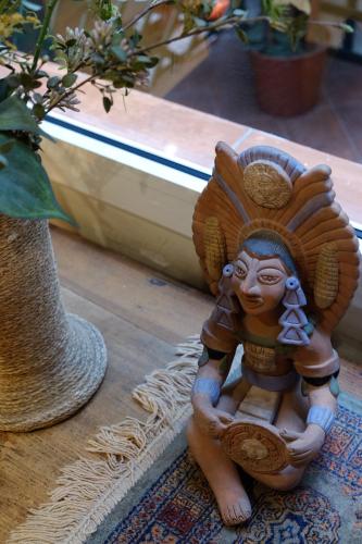 a small statue sitting on a floor next to a vase at Fashion House in Barcelona